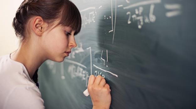 Girl doing math on chalkboard