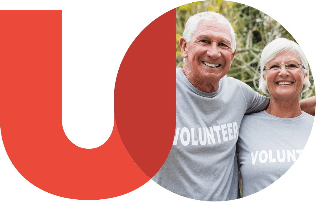 Logo featuring a circular photo of a smiling older man and woman wearing gray "Volunteer" shirts. They are overlayed by a large red "U" shape with "UNITED" in bold capital letters below.